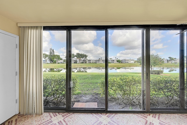 doorway with a wealth of natural light and a water view