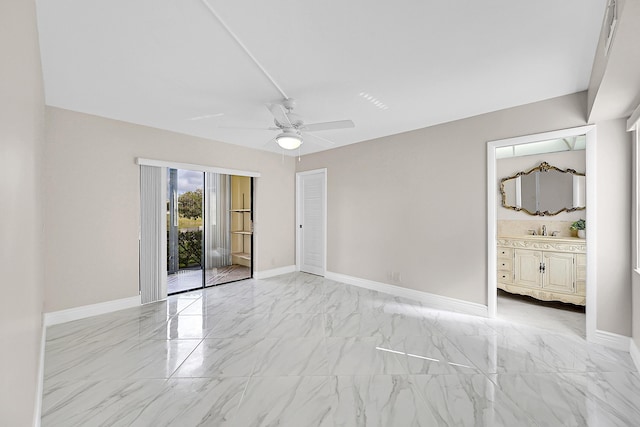 unfurnished bedroom with marble finish floor, access to outside, baseboards, and a sink