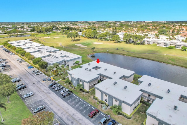 drone / aerial view with a water view and golf course view