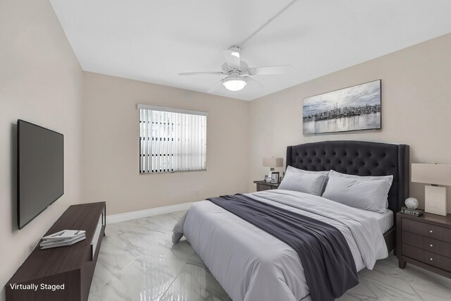 bedroom with marble finish floor, a ceiling fan, and baseboards