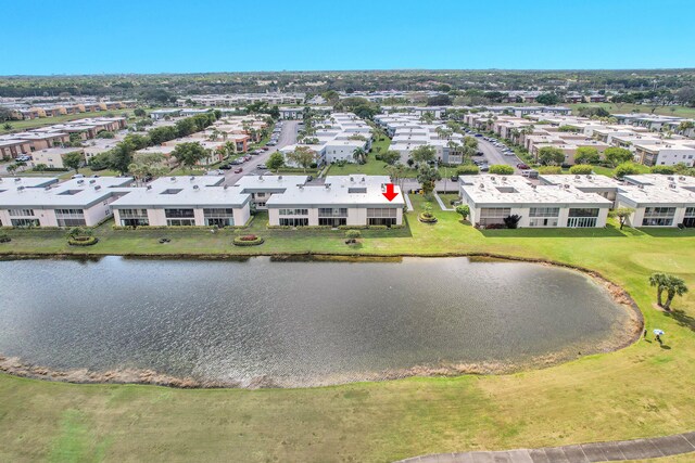 drone / aerial view featuring a residential view and a water view