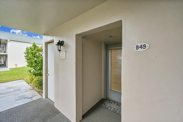 doorway to property with a patio and stucco siding