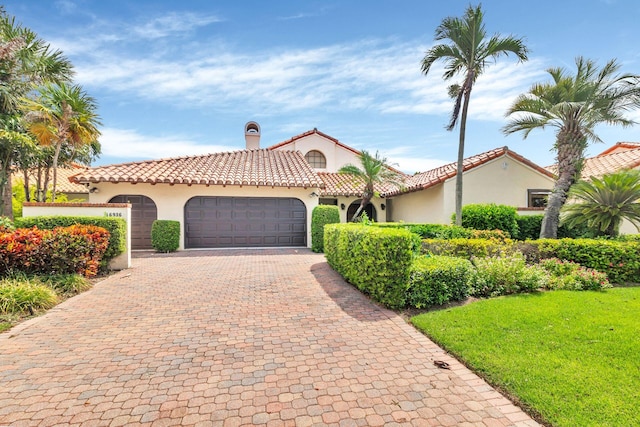 mediterranean / spanish home featuring a garage