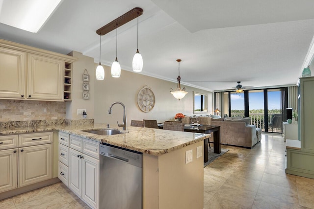 kitchen featuring stainless steel dishwasher, kitchen peninsula, and sink