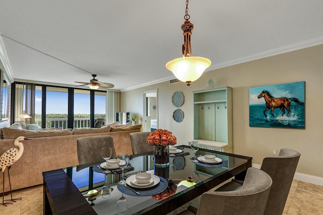 dining area featuring ceiling fan and ornamental molding