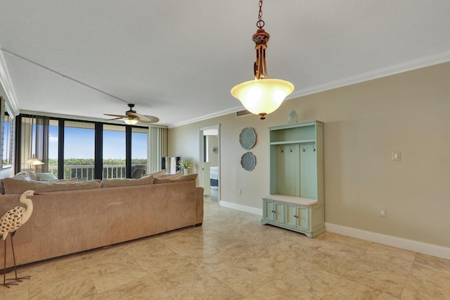 living room featuring a ceiling fan, baseboards, and ornamental molding