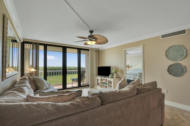 living room with ceiling fan, a wall of windows, ornamental molding, and a textured ceiling