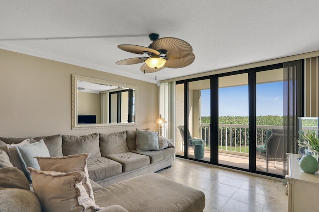 living room featuring a wall of windows, light tile patterned flooring, crown molding, and ceiling fan