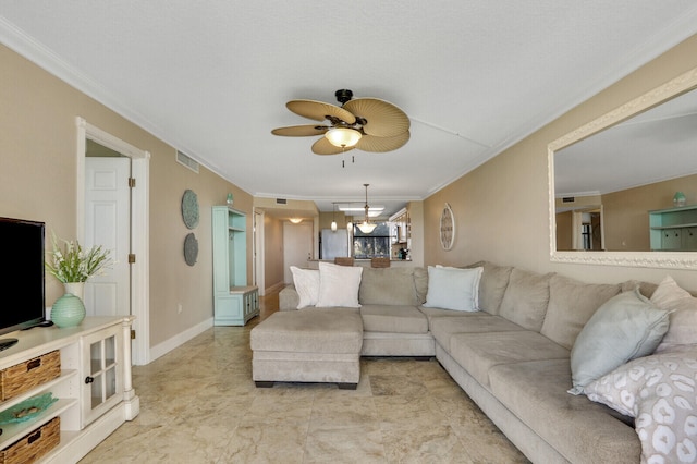 living room featuring crown molding and ceiling fan with notable chandelier