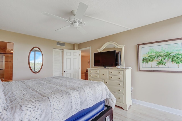 bedroom with a ceiling fan, baseboards, visible vents, and light wood finished floors