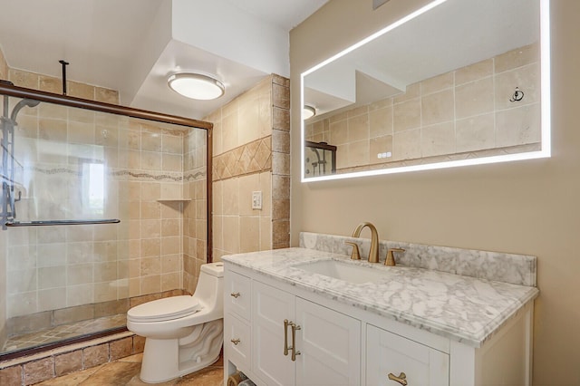 bathroom featuring a stall shower, toilet, and vanity