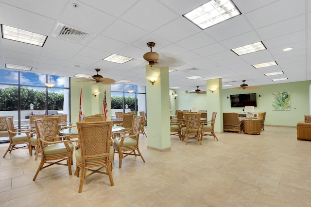 dining room featuring visible vents, a paneled ceiling, baseboards, and a ceiling fan