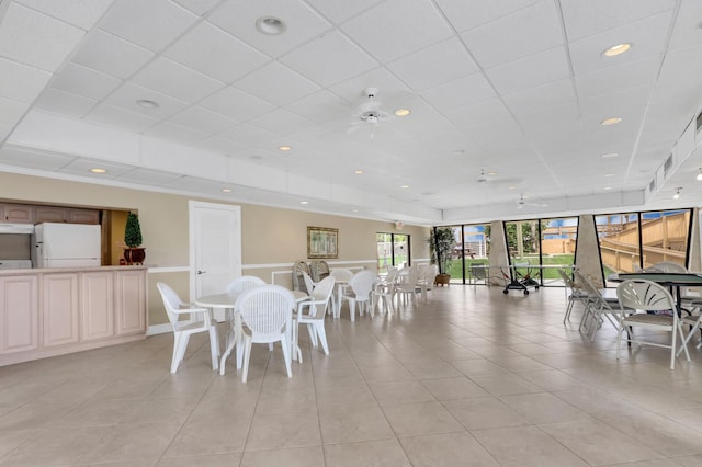 10600 S Ocean Dr Unit 109, Jensen Beach, FL 34957 - dining space featuring light tile patterned floors, a drop ceiling, recessed lighting, and a wainscoted wall