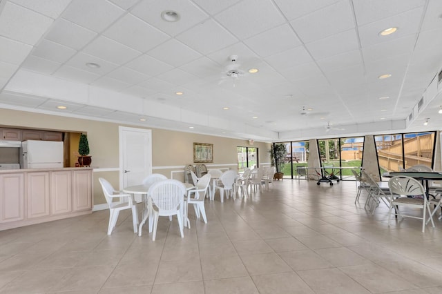 dining area with light tile patterned floors, a drop ceiling, and recessed lighting