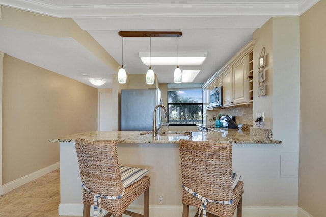 kitchen featuring light stone counters, open shelves, a peninsula, a sink, and stainless steel appliances