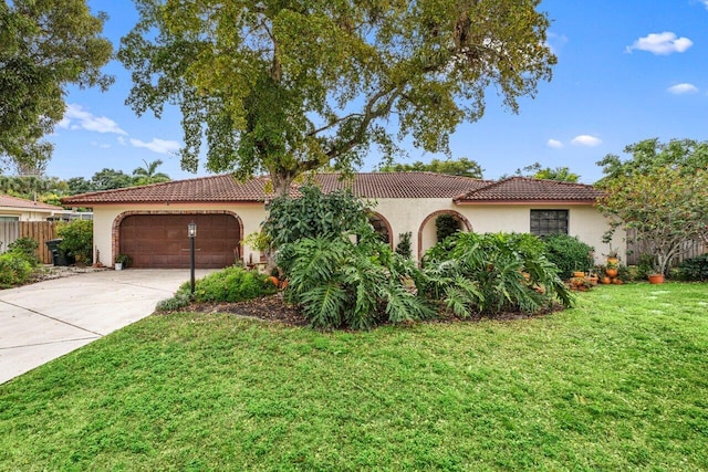 mediterranean / spanish-style house featuring driveway, a garage, stucco siding, a tile roof, and a front yard