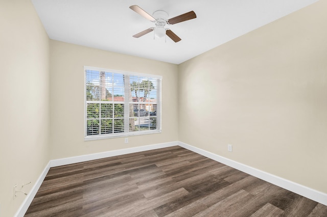 empty room with dark wood-type flooring and ceiling fan