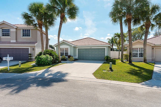 view of front of home featuring a garage and a front lawn