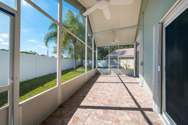 unfurnished sunroom with ceiling fan