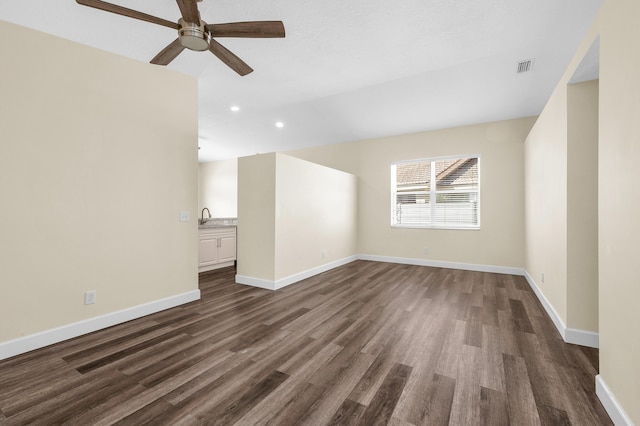 empty room with ceiling fan, dark hardwood / wood-style floors, and sink