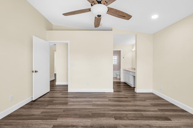 unfurnished bedroom featuring ceiling fan, lofted ceiling, dark hardwood / wood-style floors, and ensuite bath