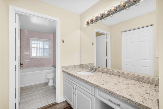 bathroom with vanity, wood-type flooring, and toilet