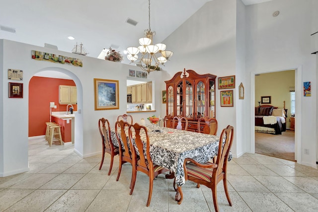 9158 Heathridge Dr, West Palm Beach, FL 33411 - dining area with sink, a chandelier, high vaulted ceiling, and light tile patterned floors