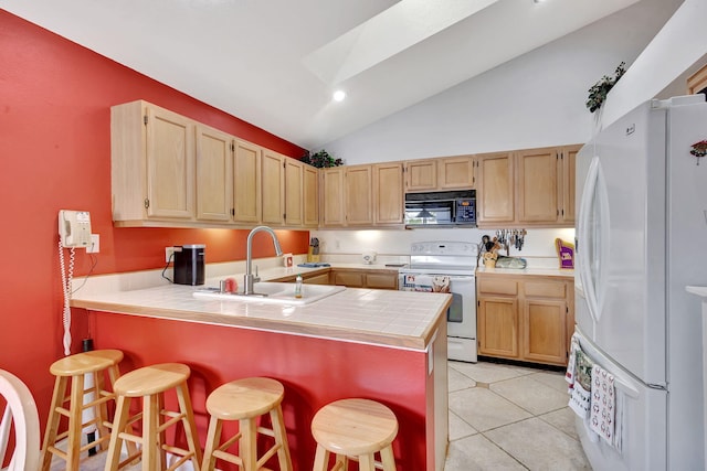 9158 Heathridge Dr, West Palm Beach, FL 33411 - kitchen featuring white appliances, a breakfast bar, kitchen peninsula, and sink