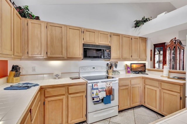 9158 Heathridge Dr, West Palm Beach, FL 33411 - kitchen featuring light tile patterned floors, vaulted ceiling, electric range, tile countertops, and light brown cabinets
