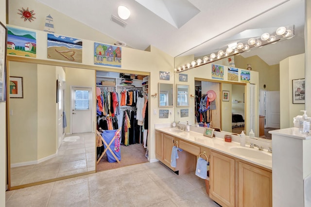 9158 Heathridge Dr, West Palm Beach, FL 33411 - bathroom with tile patterned floors, vanity, and vaulted ceiling