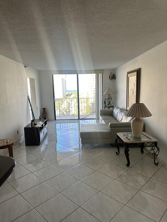 290 174th St Unit 1111, Sunny Isles Beach, FL 33160 - living area with light tile patterned flooring and a textured ceiling