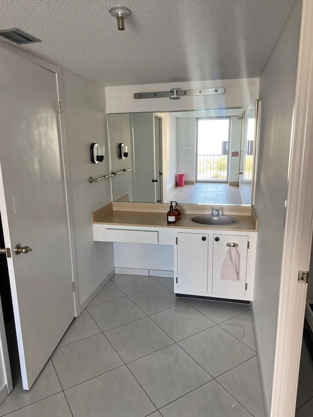 290 174th St Unit 1111, Sunny Isles Beach, FL 33160 - bathroom with a textured ceiling, tile patterned floors, and vanity