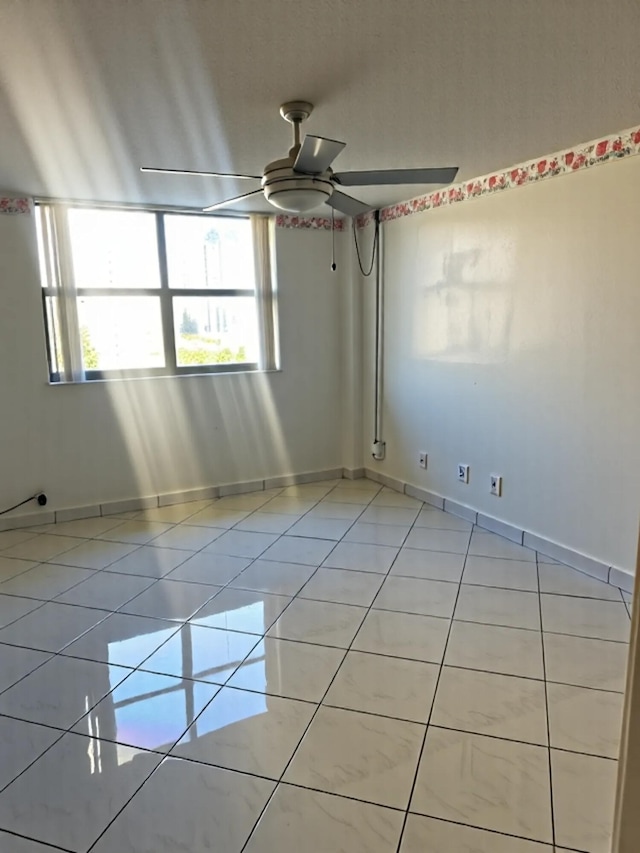 290 174th St Unit 1111, Sunny Isles Beach, FL 33160 - spare room with a ceiling fan, light tile patterned floors, plenty of natural light, and baseboards
