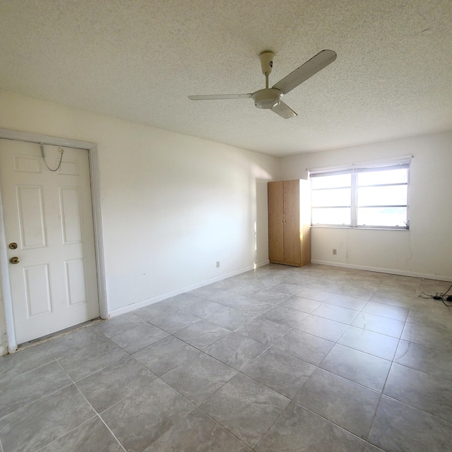 unfurnished room featuring a textured ceiling and ceiling fan