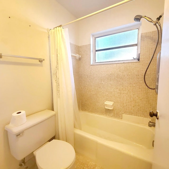 bathroom with shower / tub combo with curtain and toilet