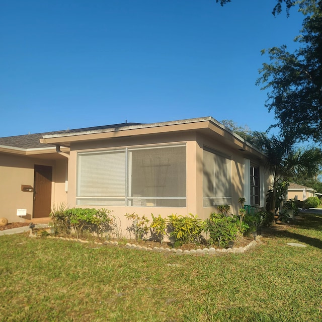 view of side of property with a yard