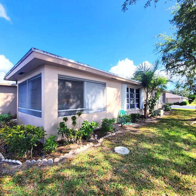 view of home's exterior featuring a lawn