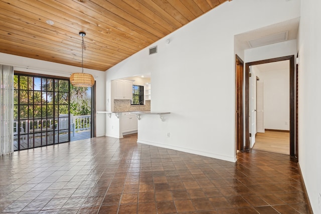 unfurnished living room featuring dark tile patterned flooring, vaulted ceiling, and wooden ceiling