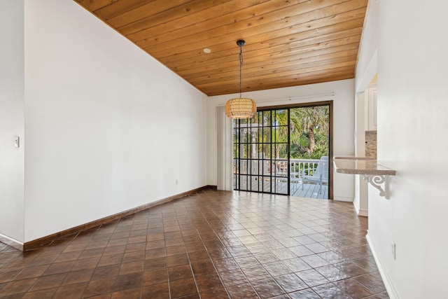 spare room with vaulted ceiling and wooden ceiling