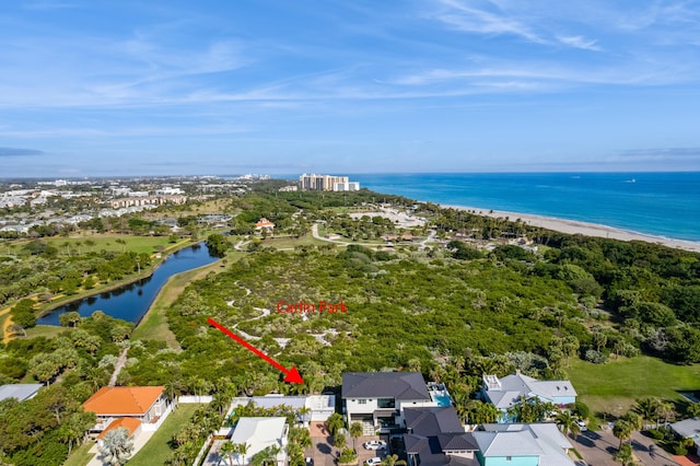 bird's eye view with a water view and a beach view