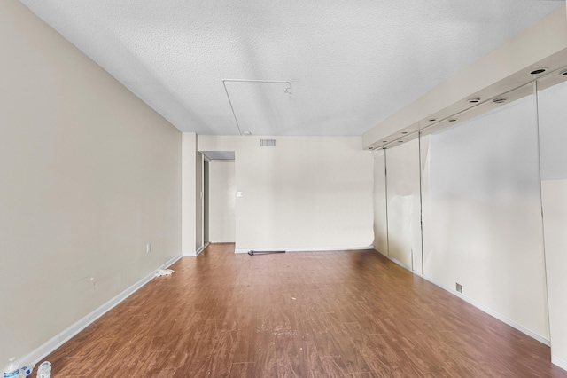 2802 N 46th Ave Unit B513, Hollywood, FL 33021 - empty room with visible vents, wood finished floors, baseboards, and a textured ceiling
