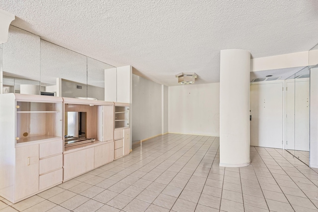 2802 N 46th Ave Unit B513, Hollywood, FL 33021 - unfurnished living room with light tile patterned flooring and a textured ceiling