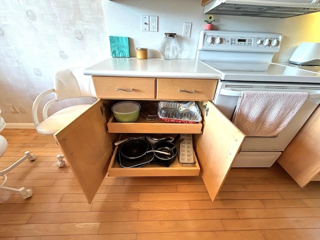 kitchen with ventilation hood, electric range, and light wood-type flooring