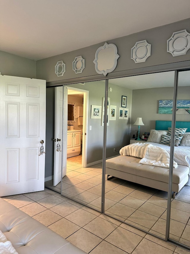 tiled bedroom featuring a closet