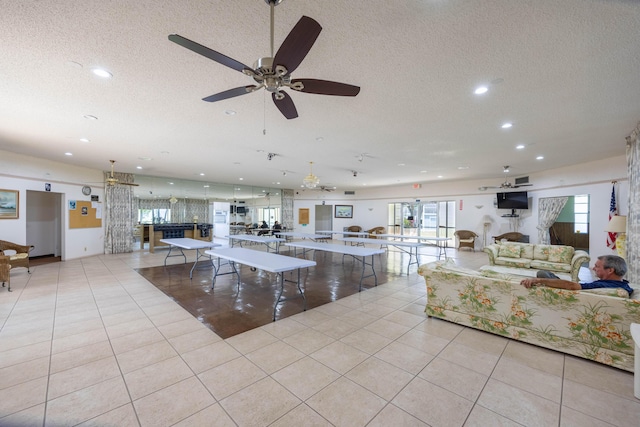 unfurnished living room featuring light tile patterned floors and a textured ceiling