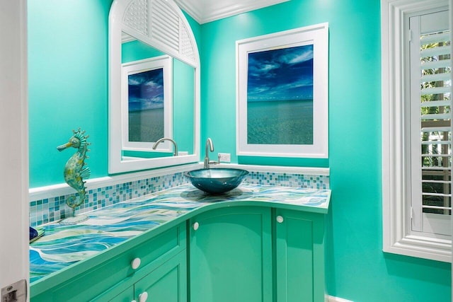 bathroom with crown molding, vanity, and decorative backsplash