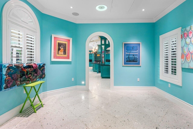 interior space with arched walkways, ornamental molding, recessed lighting, and baseboards