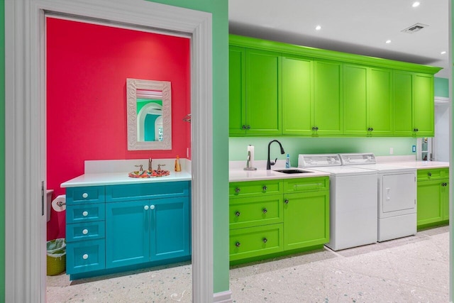 clothes washing area featuring cabinet space, visible vents, washing machine and dryer, a sink, and recessed lighting