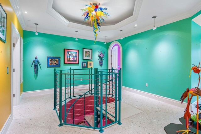 interior space with light speckled floor, recessed lighting, baseboards, a raised ceiling, and crown molding