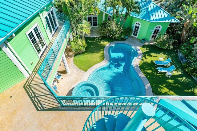 view of swimming pool with a yard, a patio, and an outdoor structure